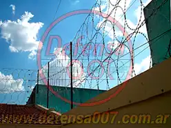 Instalación de concertina plana de 65 cm en triple capa sobre medianera techo de tejas.